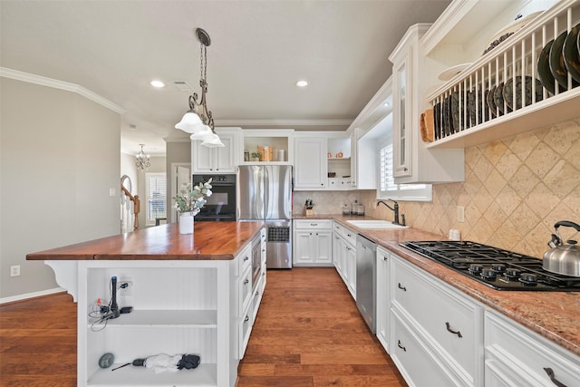 kitchen with butcher block countertops, sink, white cabinets, black appliances, and crown molding