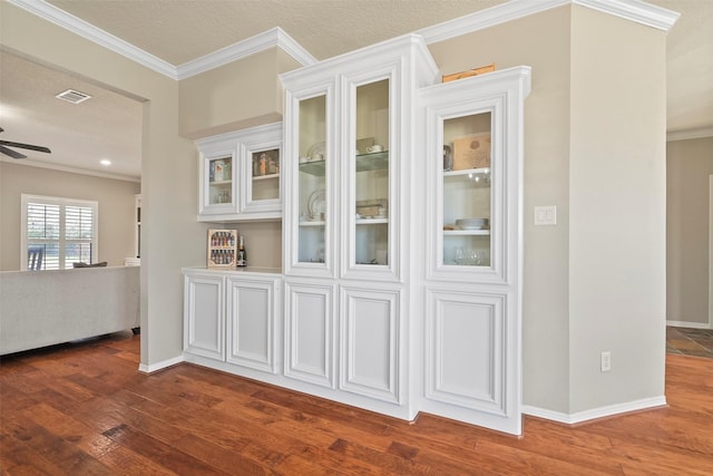 interior details featuring crown molding, ceiling fan, hardwood / wood-style floors, and a textured ceiling