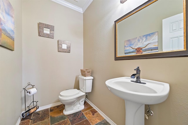 bathroom featuring ornamental molding and toilet