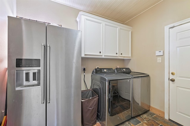 laundry room with washing machine and dryer and cabinets