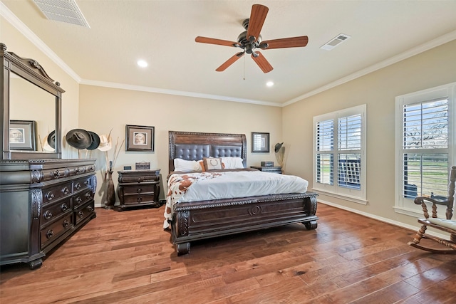 bedroom with crown molding, hardwood / wood-style floors, and ceiling fan