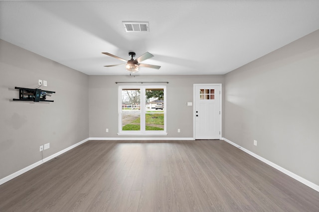 spare room with hardwood / wood-style flooring and ceiling fan