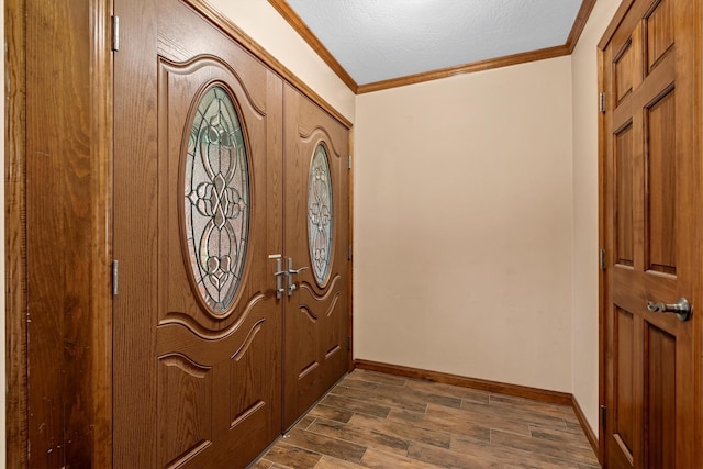 foyer entrance with ornamental molding, dark hardwood / wood-style floors, and a textured ceiling