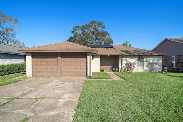 ranch-style house featuring driveway, solar panels, an attached garage, a shingled roof, and a front lawn