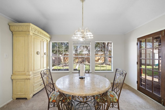 dining area with baseboards, a chandelier, ornamental molding, and light colored carpet