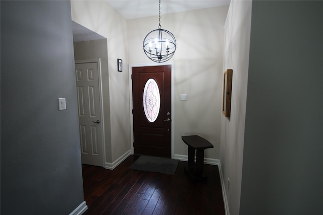 foyer entrance featuring dark hardwood / wood-style floors and a notable chandelier