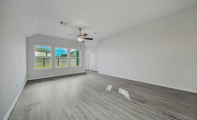 unfurnished room with lofted ceiling, dark wood-type flooring, and ceiling fan