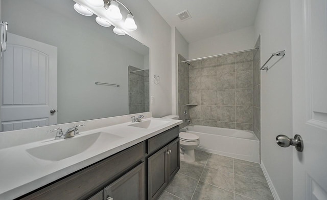 full bathroom with tiled shower / bath, vanity, toilet, and tile patterned flooring