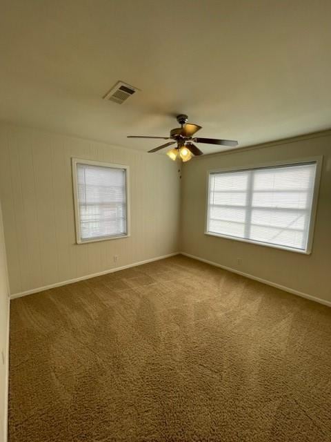 spare room featuring carpet flooring and ceiling fan