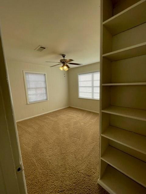 carpeted spare room featuring ceiling fan