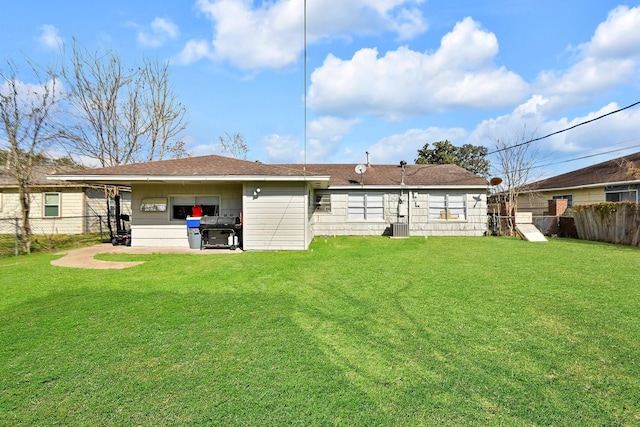 rear view of house featuring a lawn and a patio area