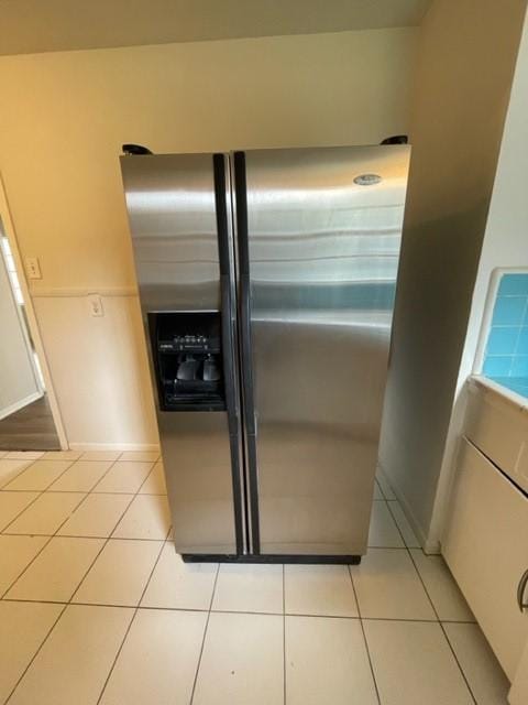 interior details with white cabinetry and stainless steel fridge