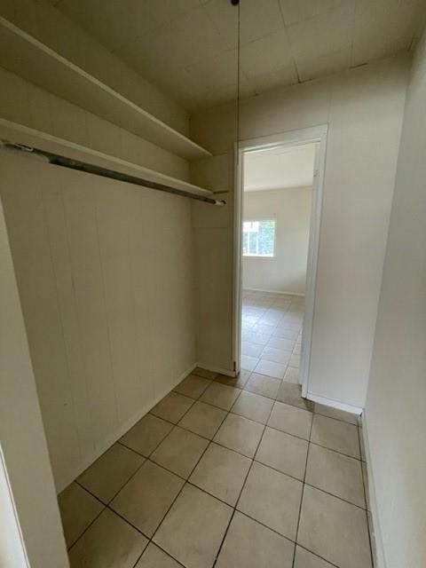 spacious closet with light tile patterned floors