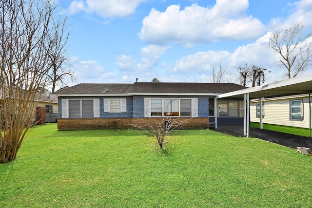 ranch-style home featuring a carport and a front lawn