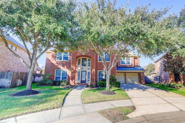 view of front of home with a garage and a front yard