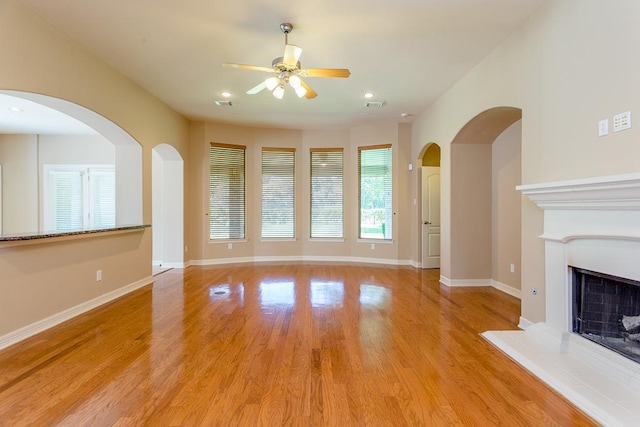 unfurnished living room featuring ceiling fan and light wood-type flooring