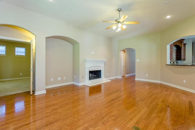 unfurnished living room with ceiling fan and light hardwood / wood-style flooring