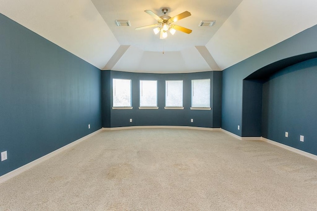 carpeted empty room featuring vaulted ceiling and ceiling fan