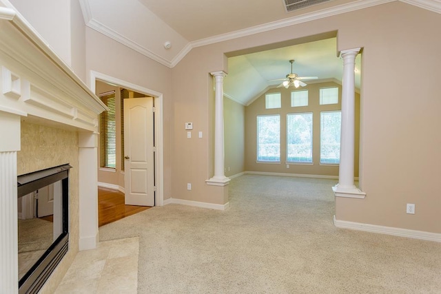 unfurnished living room with ornate columns, lofted ceiling, a premium fireplace, a healthy amount of sunlight, and light carpet