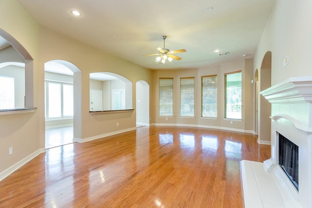 unfurnished living room featuring ceiling fan and light hardwood / wood-style flooring