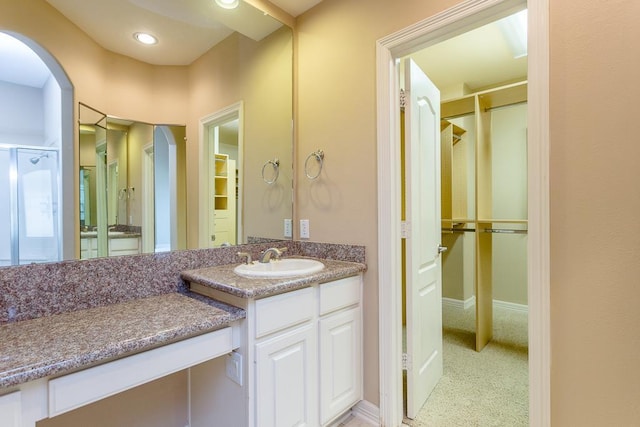 bathroom with vanity and a shower with shower door