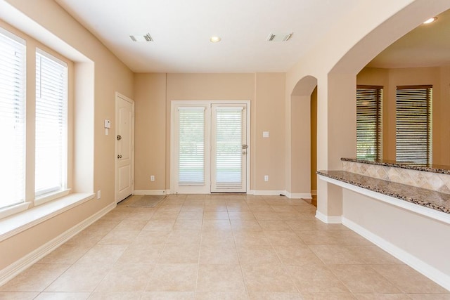 entryway with light tile patterned floors