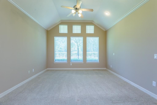 carpeted spare room featuring crown molding, ceiling fan, and vaulted ceiling