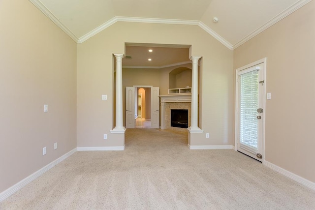 unfurnished living room featuring vaulted ceiling, ornamental molding, light colored carpet, a fireplace, and decorative columns