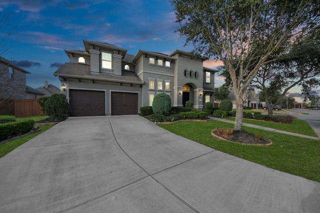 view of front facade featuring a garage and a lawn