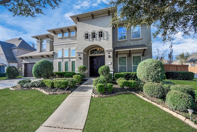 view of front of property featuring a garage and a front lawn