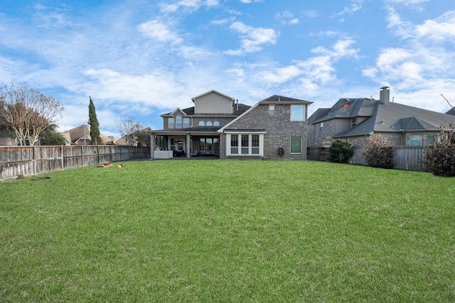 rear view of house with a lawn