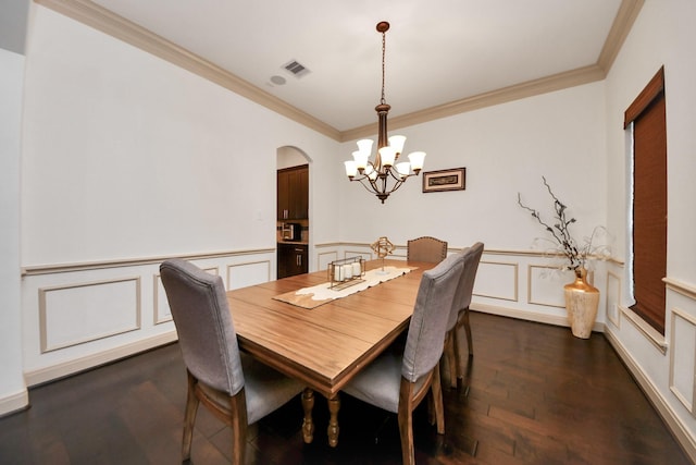 dining area with crown molding, dark hardwood / wood-style floors, and a notable chandelier