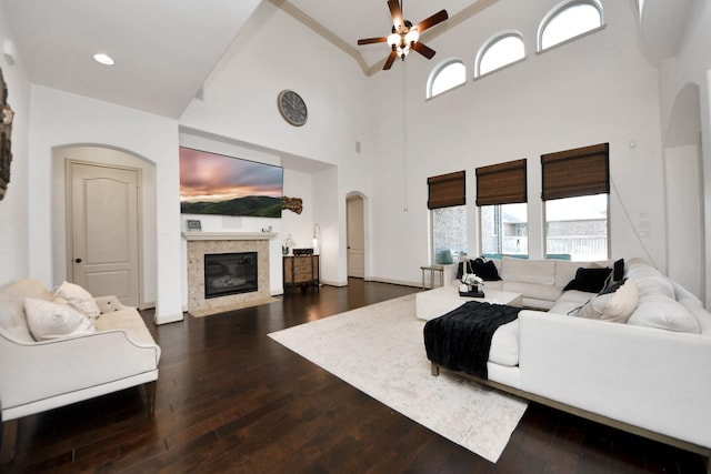 living room with ceiling fan, plenty of natural light, and dark hardwood / wood-style flooring