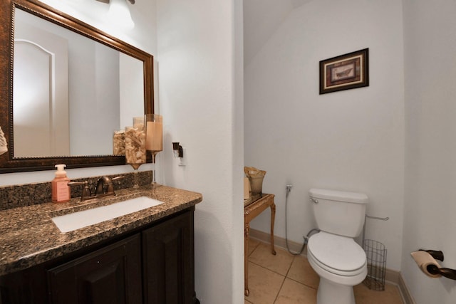 bathroom featuring vanity, tile patterned floors, and toilet