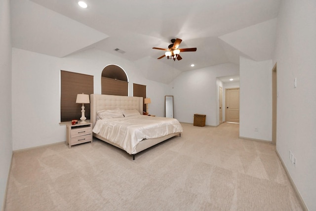 bedroom featuring ceiling fan, vaulted ceiling, and light carpet