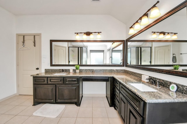 bathroom with lofted ceiling, tile patterned flooring, and vanity