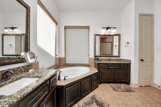 bathroom featuring vanity, a tub to relax in, and tile patterned flooring