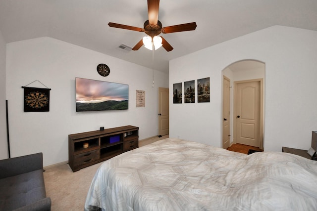 carpeted bedroom with ceiling fan and vaulted ceiling