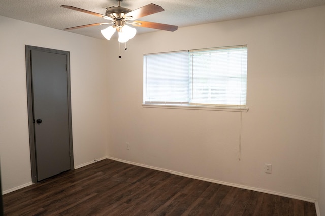 spare room featuring ceiling fan, dark hardwood / wood-style floors, and a textured ceiling