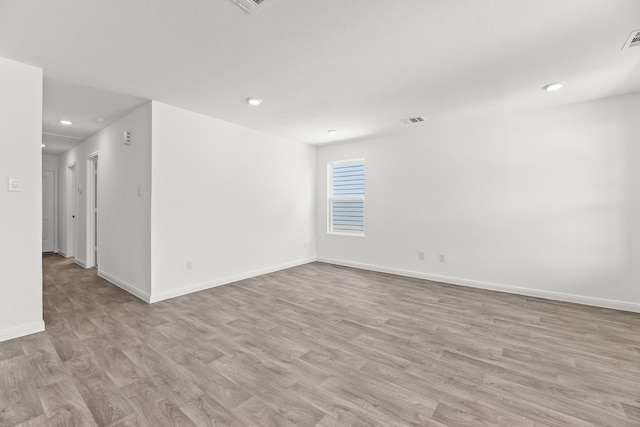 empty room with light hardwood / wood-style floors