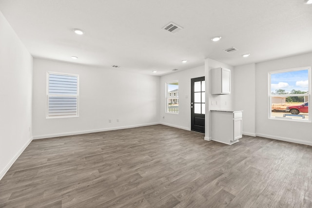 unfurnished living room featuring wood-type flooring