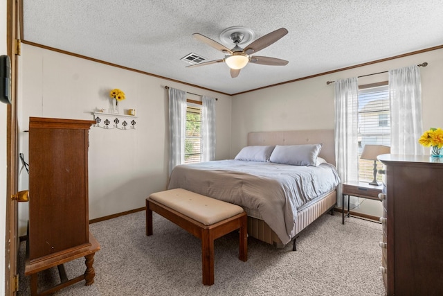 bedroom featuring light colored carpet, ornamental molding, and a textured ceiling