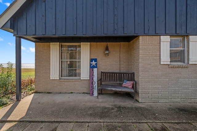 view of exterior entry featuring a patio area