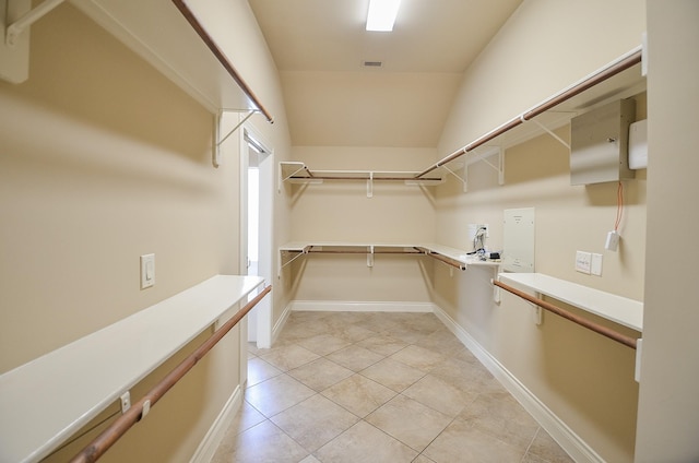 walk in closet with light tile patterned flooring