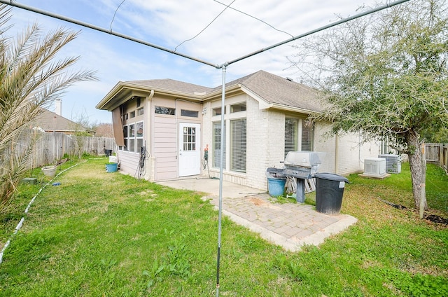 back of property with cooling unit, a yard, and a patio