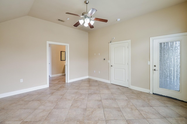 empty room with vaulted ceiling, ceiling fan, and light tile patterned flooring