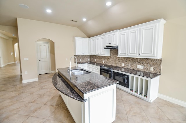 kitchen with sink, backsplash, white cabinets, dark stone counters, and black appliances