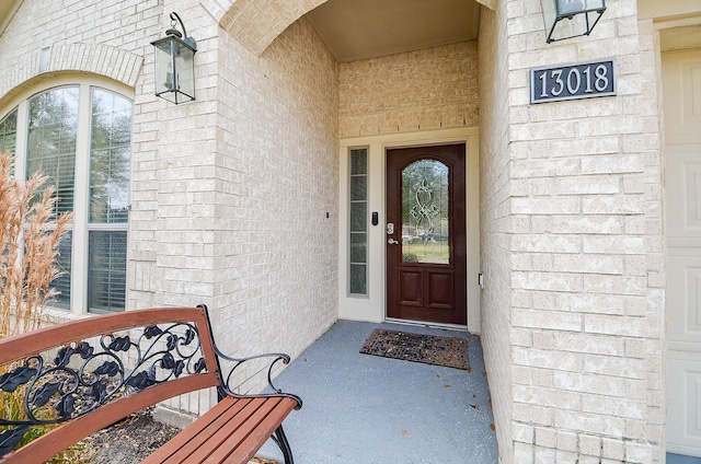 doorway to property with brick siding