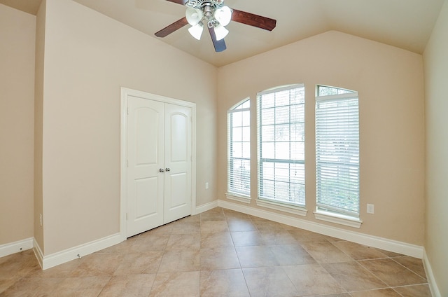 unfurnished room featuring vaulted ceiling, light tile patterned flooring, and ceiling fan