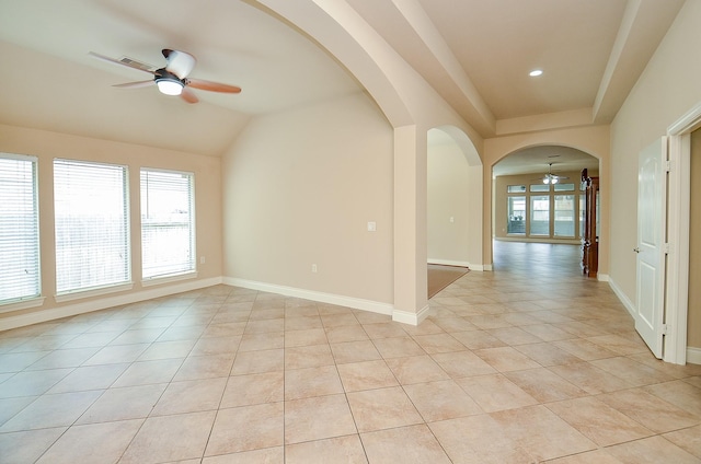 empty room with light tile patterned flooring, lofted ceiling, and ceiling fan